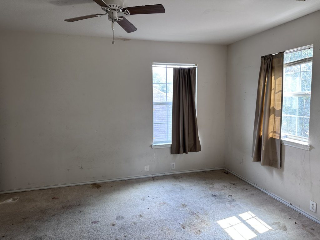 Stained bedroom carpet in a distressed Edgewick Elm Street home near Missouri City, TX