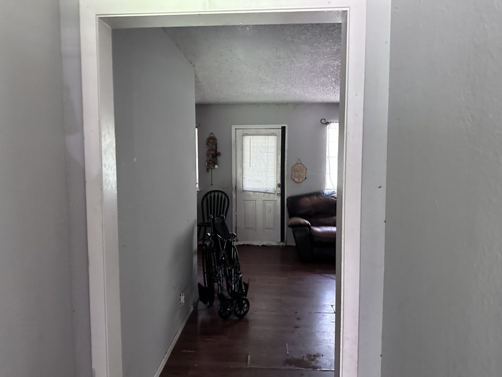 Hallway with mobility equipment inside a Northwood Manor, Houston home sold for cash