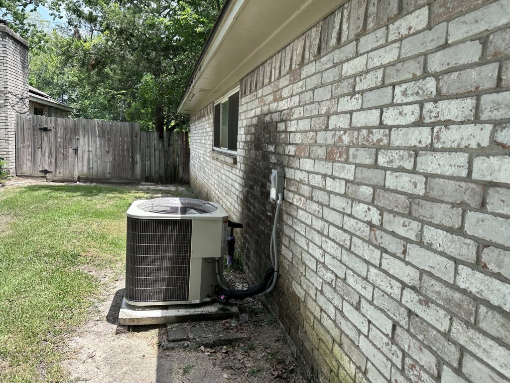 Exterior brick and AC unit at a Timber Lane home in Spring, TX sold for cash