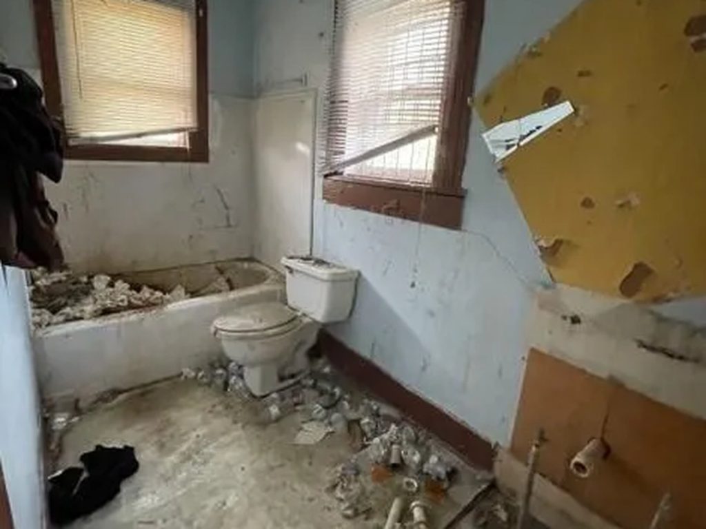 Damaged bathroom at a vacant Fifth Ward home in East Houston, TX