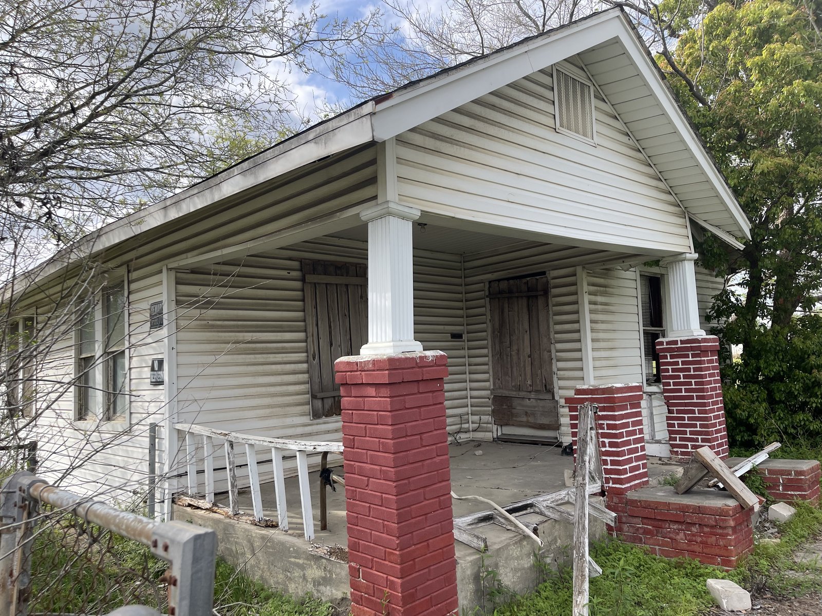 Boarded front porch of an abandoned Fifth Ward home in East Houston, TX