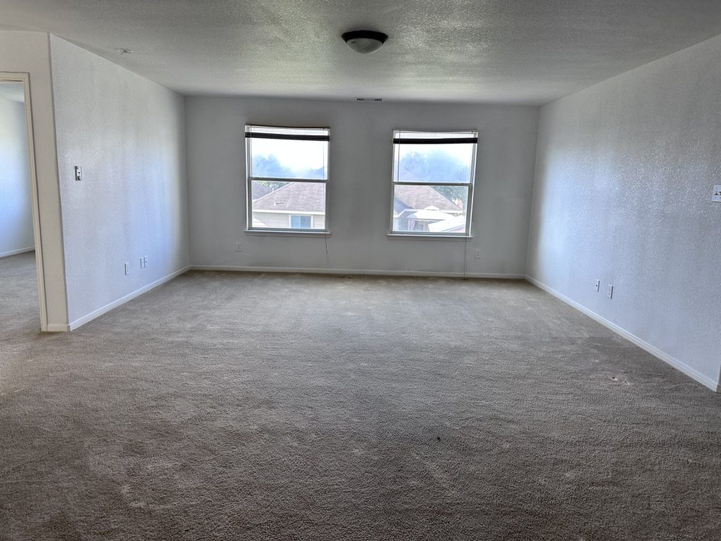 Backyard of vacant Houston TX property bought by cash home buyers