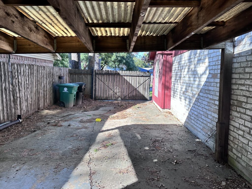 Covered breezeway at a distressed Greater Inwood, Houston home sold for cash