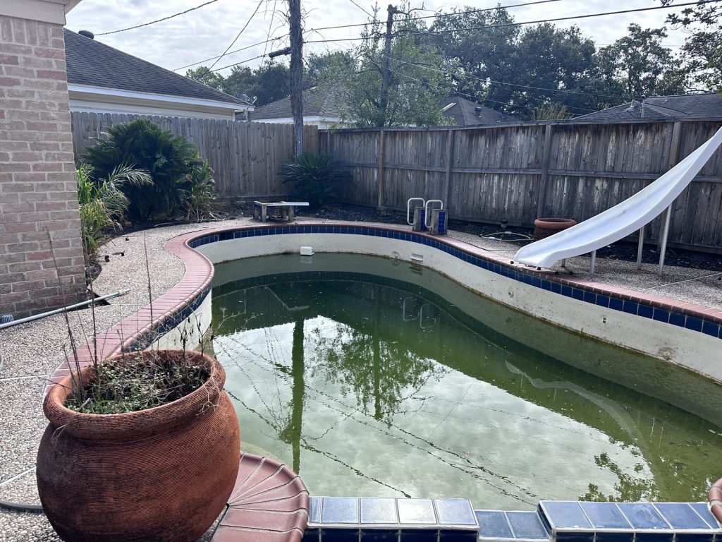 Neglected green swimming pool at a vacant Houston TX home purchased as-is for cash