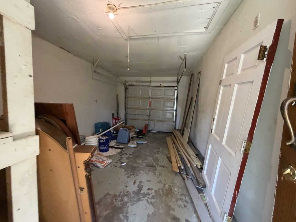 Cluttered garage of tired landlord's Houston TX property sold as-is