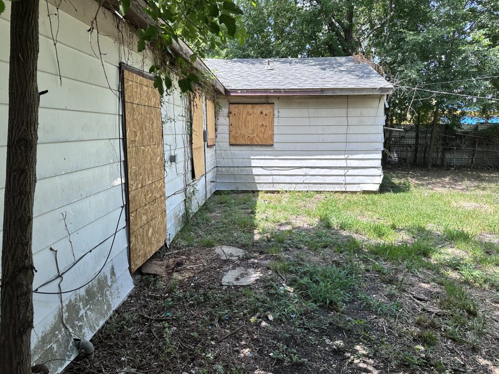 Boarded side exterior at a Lake Forest home in East Houston, TX sold for cash