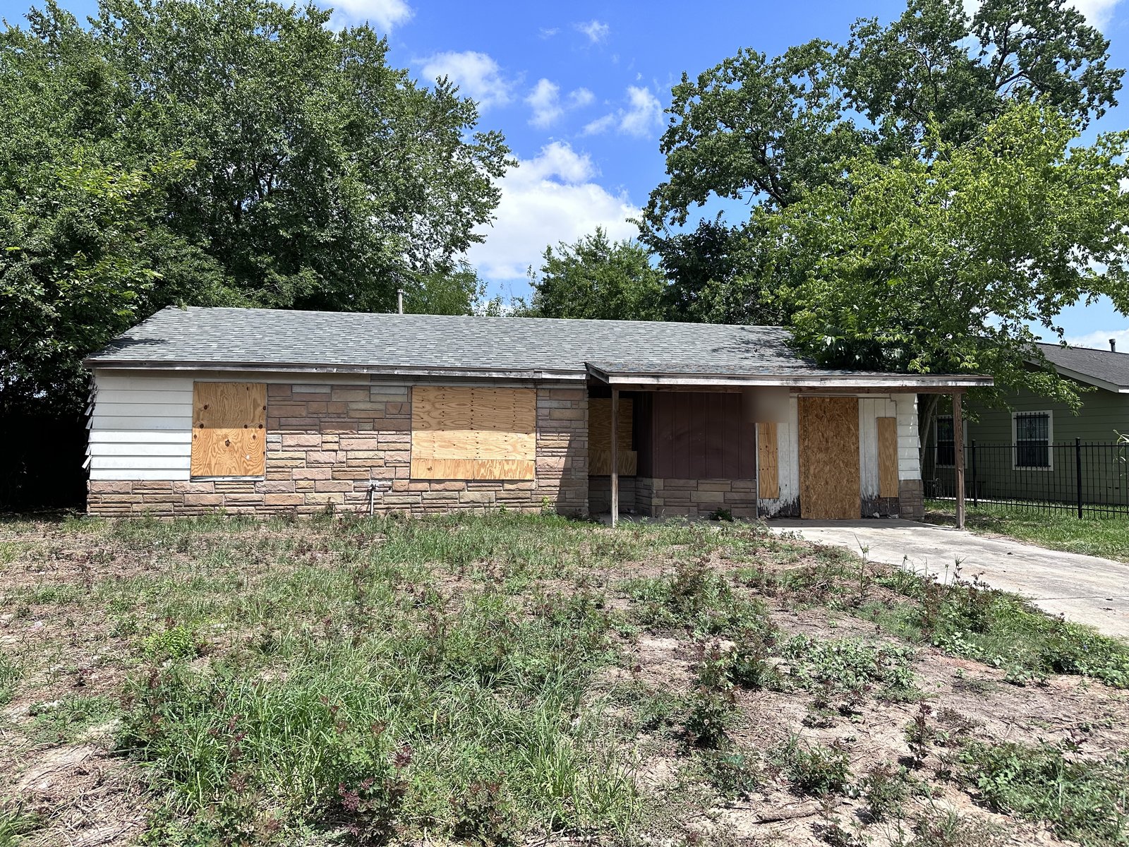 Boarded windows at a flood-damaged Lake Forest home in East Houston, TX