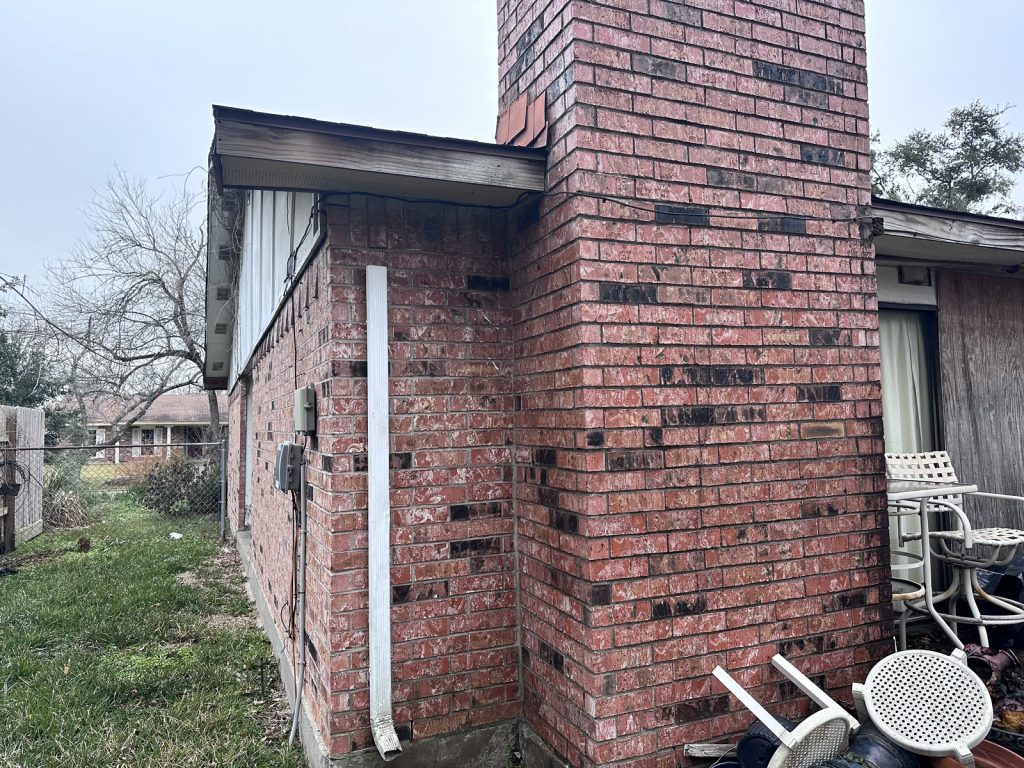 Exterior brick and chimney showing deferred maintenance on a Pine Trails rental in East Houston, TX