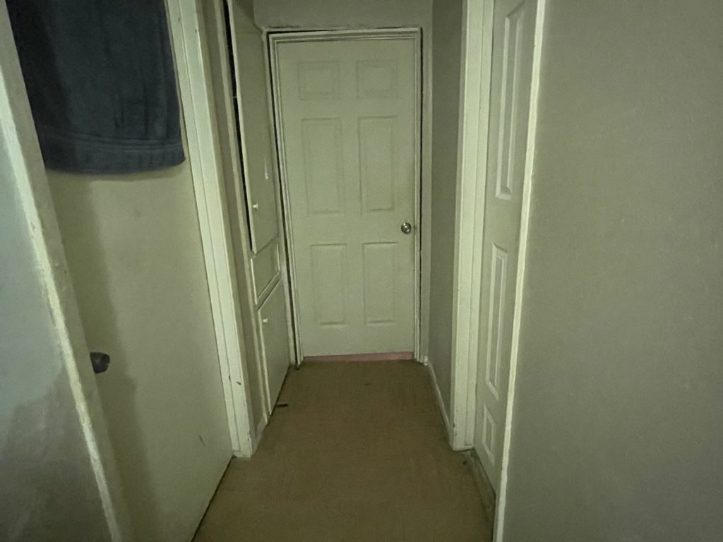 Interior hallway of a home sold quickly to stop foreclosure in Sterling Forest, Channelview
