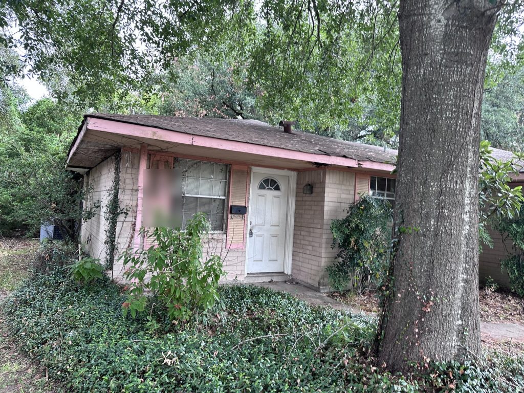Front exterior and garage of a distressed inherited home sold for cash in Hidden Valley, Houston, TX
