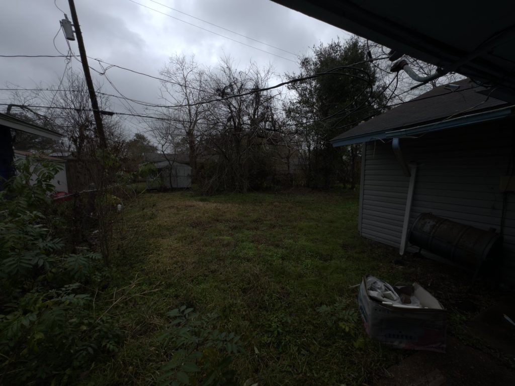 Overgrown backyard of multiple-heir property bought by Houston cash home buyers