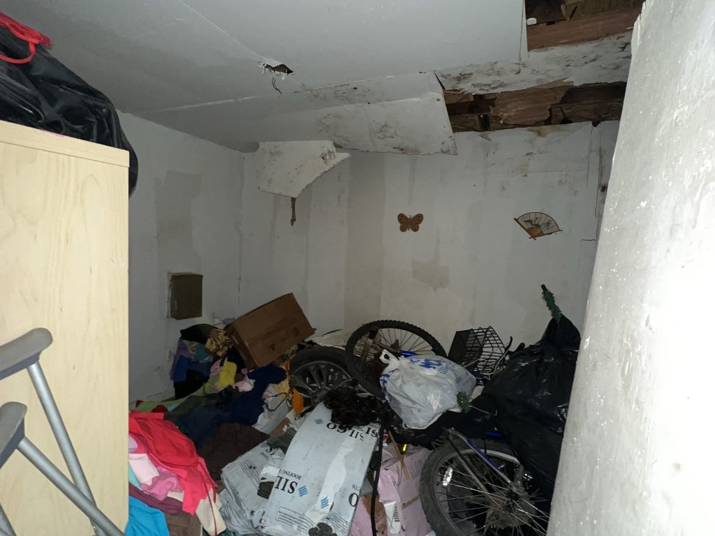 Collapsed ceiling from roof leak in as-is Houston TX home purchased for cash