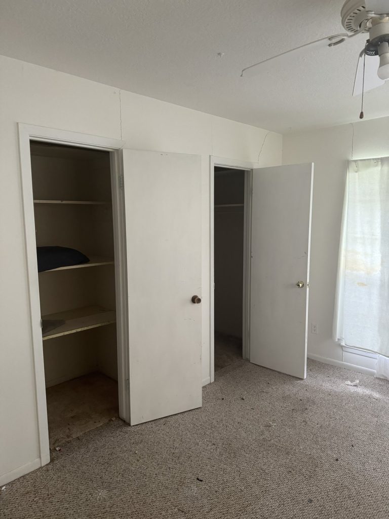 Vacant bedroom with open closets in Graywood, Baytown TX home sold for cash