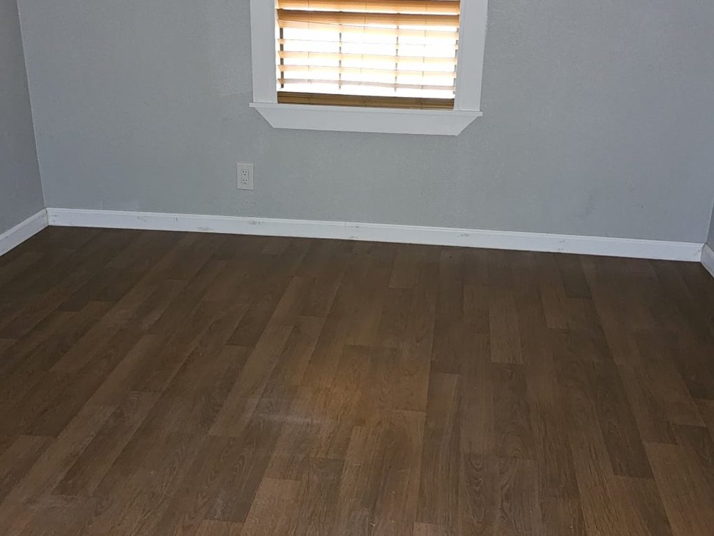 Empty bedroom with wood flooring in an inherited property sold for cash in Near Northside, Houston, TX