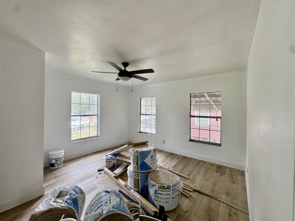 Room with insulation materials in a distressed home sold for cash in Kinwood, Aldine, TX
