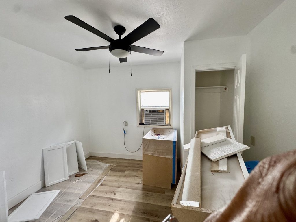 Bedroom with window AC unit in a home needing updates purchased for cash in Kinwood, Aldine, TX