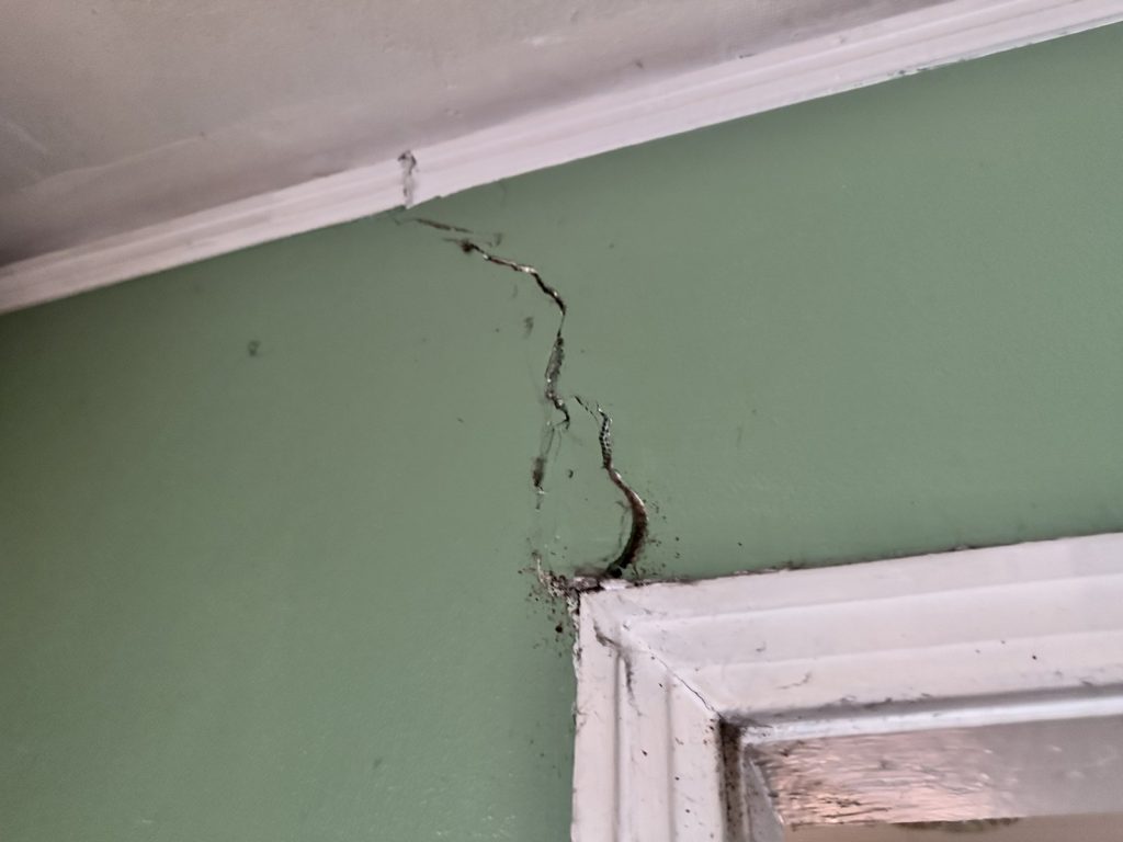 Foundation movement crack above door frame in Houston TX home sold as-is