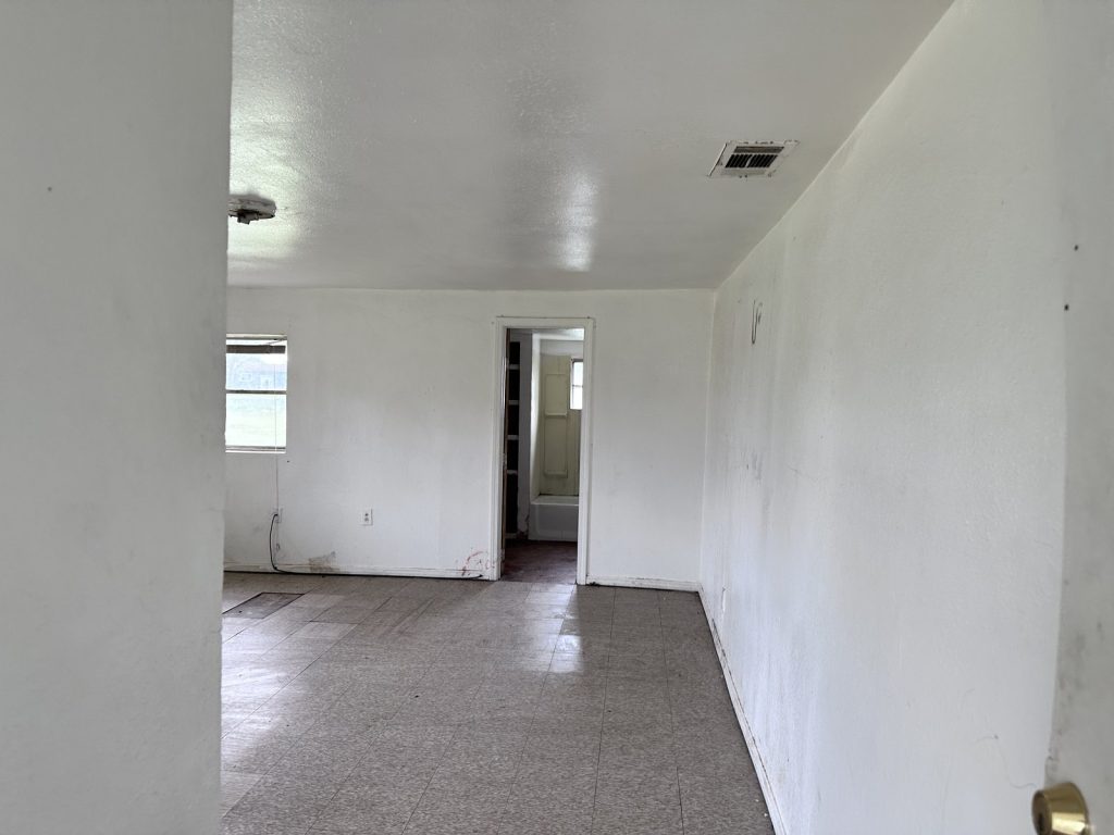 Hallway inside a vacant Hempstead, TX property purchased for cash