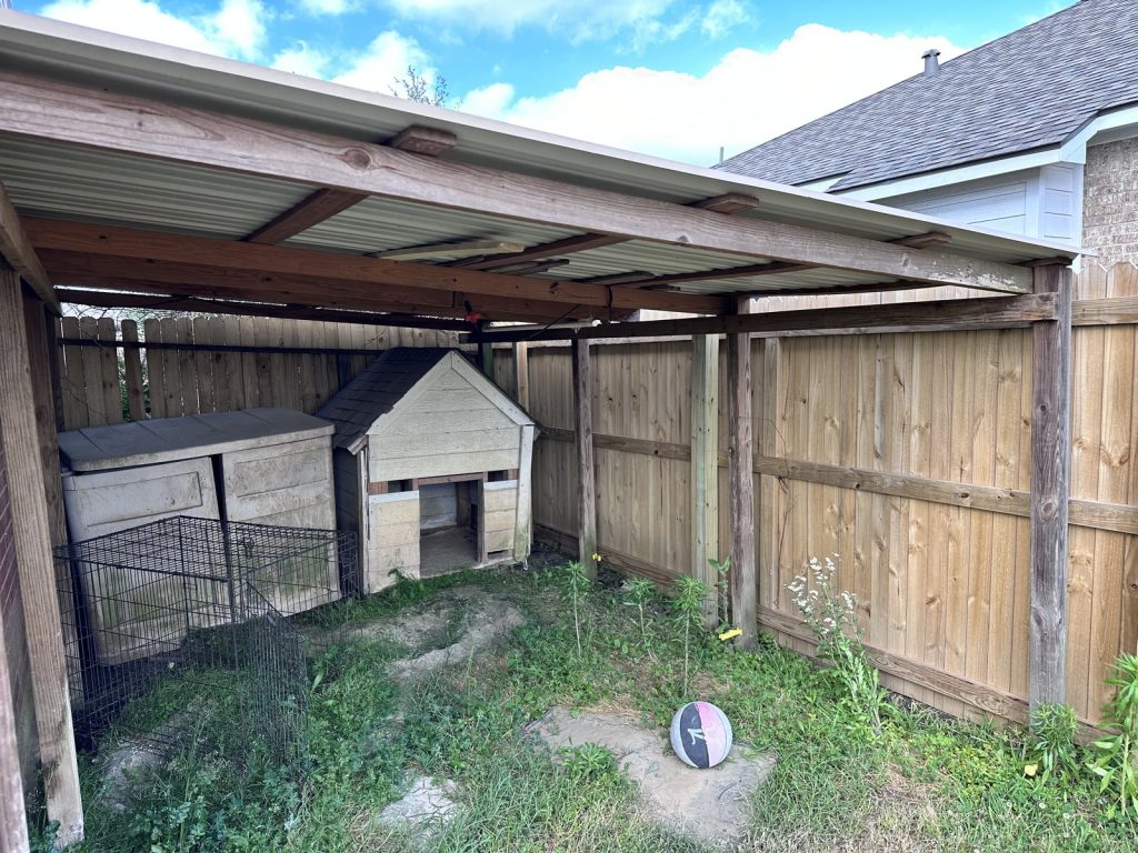Covered backyard area of a foreclosure home purchased for cash in Dayton, TX