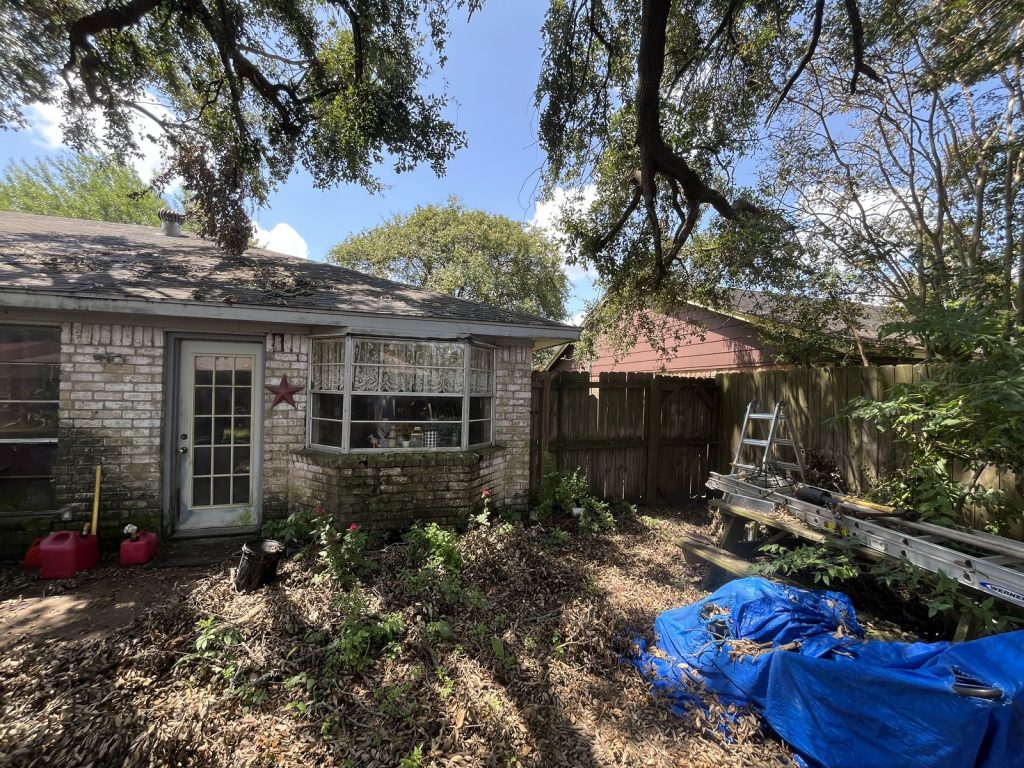 Rear view of as-is brick ranch home bought for cash in Deer Park TX