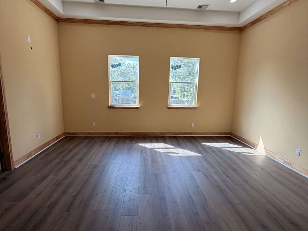 Empty bedroom in unfinished Hitchcock TX home bought by cash home buyers