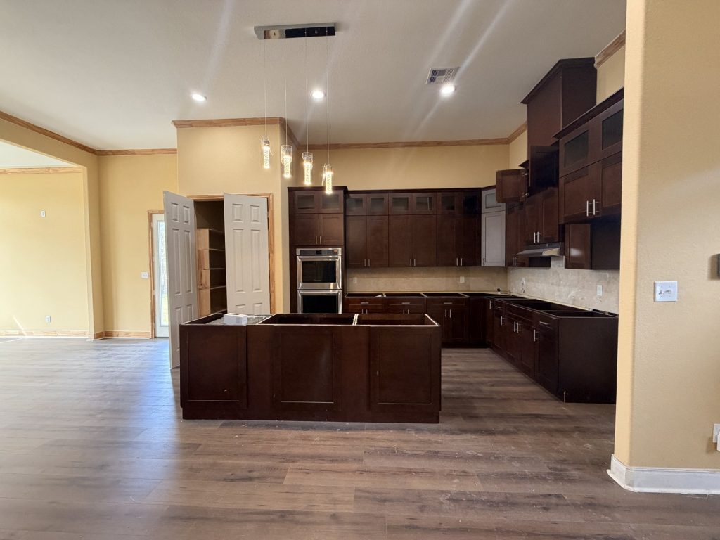 Unfinished kitchen with no countertops in foreclosure home purchased as-is in Hitchcock TX