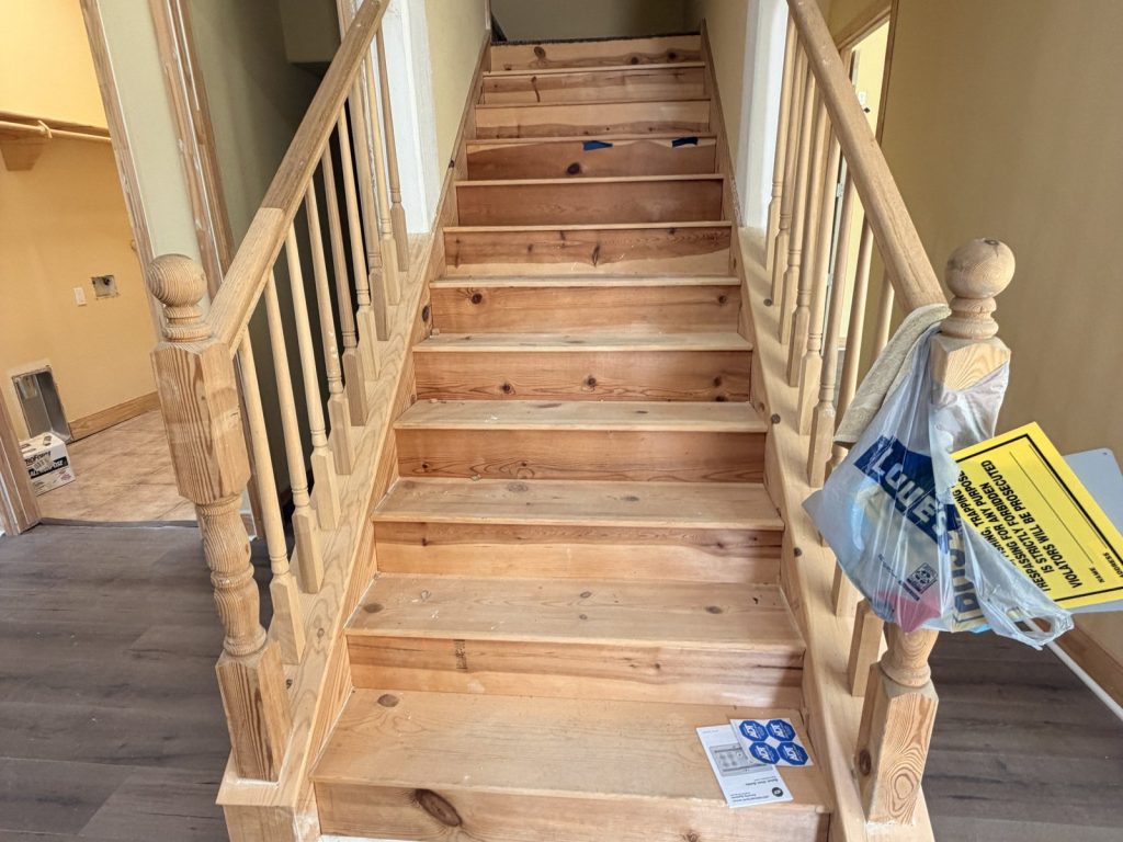 Bare unfinished staircase in abandoned new build sold for cash in Hitchcock TX