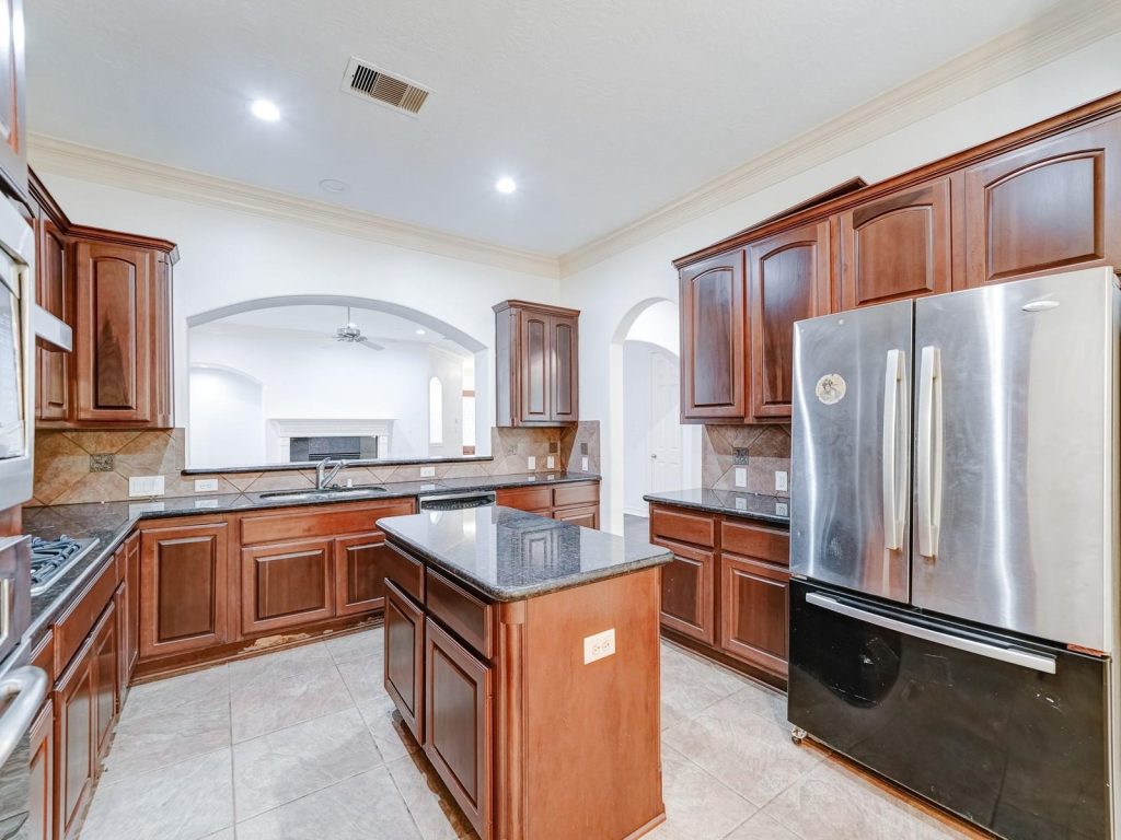 Cherry cabinet kitchen in Energy Corridor Houston TX house purchased as-is for cash