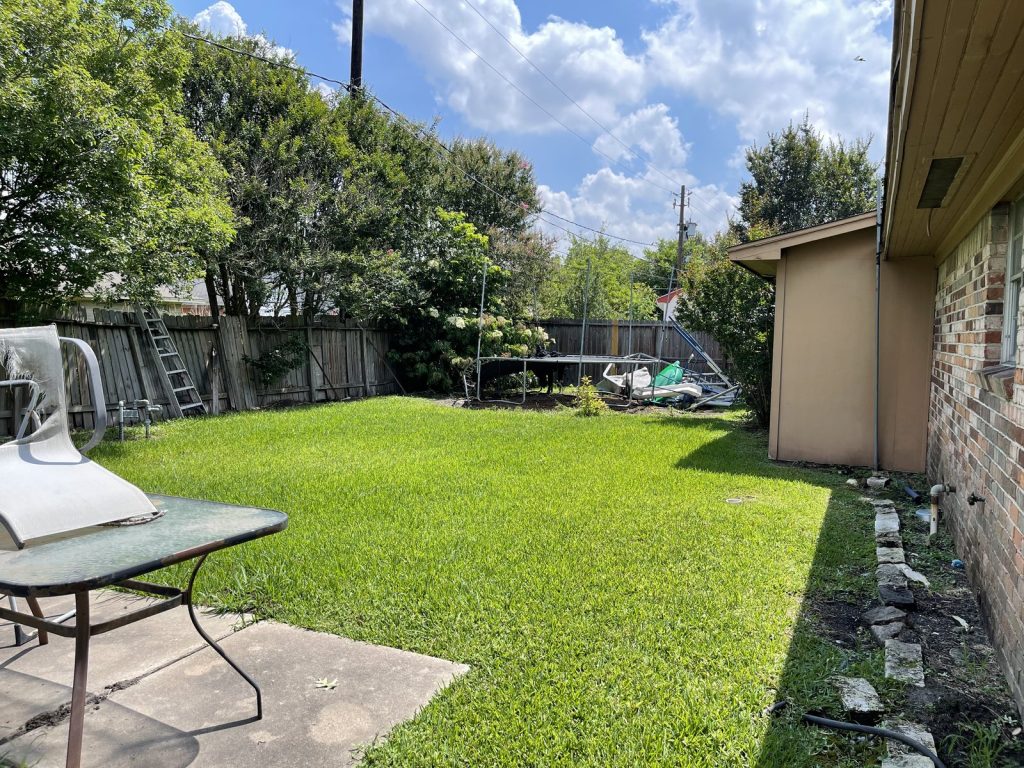Fenced backyard of rental property purchased as-is in Edgebrook, Houston TX