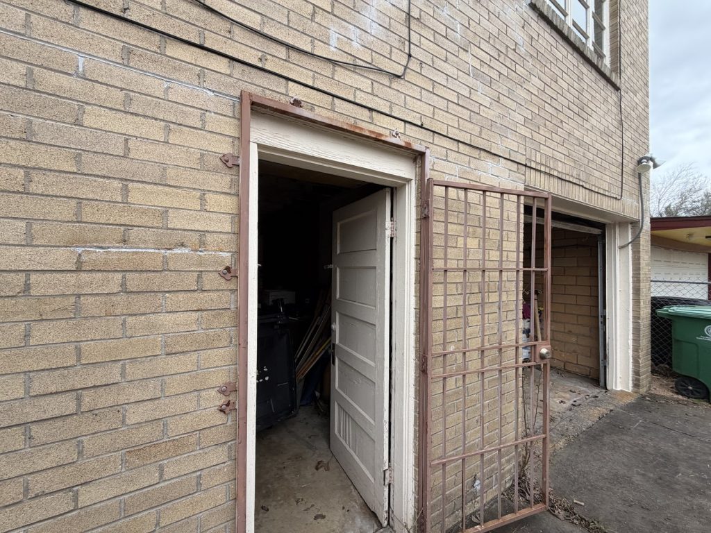 Open garage of abandoned rental property purchased for cash in Houston TX