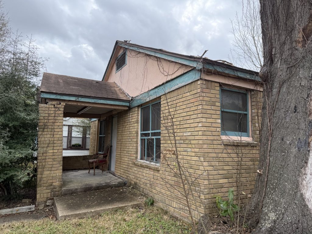 Abandoned blond-brick home with failing roof bought for cash in South Central Houston TX