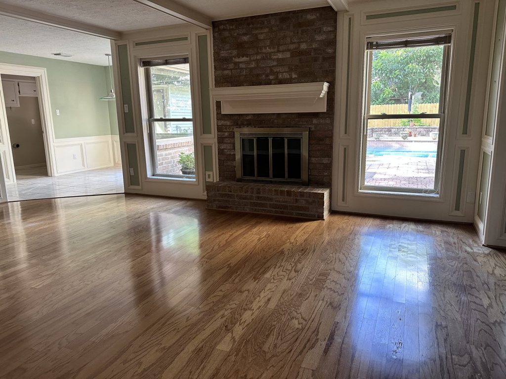 Family room with fireplace and pool view in a Pebbleton Drive home in Houston, TX