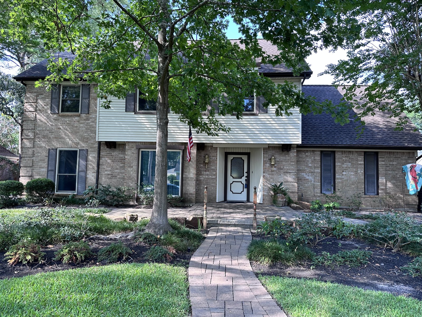 Front exterior of a two-story brick home in Lakewood Forest, Houston TX sold for cash