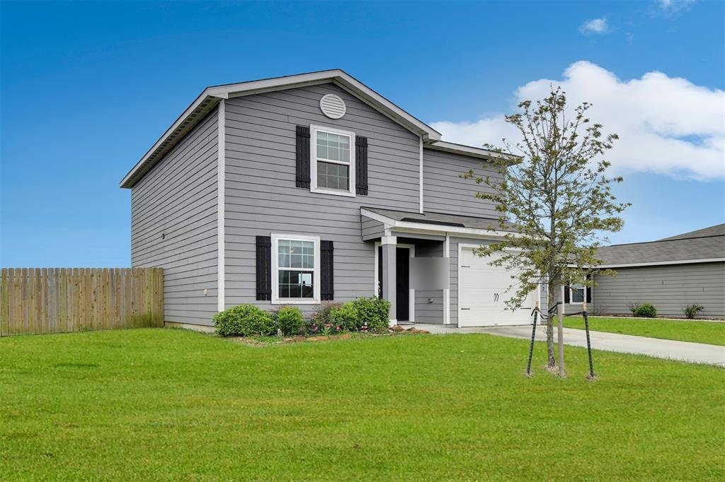 Front exterior of newer two-story home bought for cash in Mont Belvieu, TX