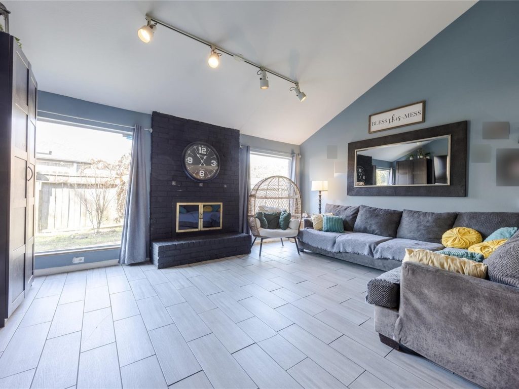 Vaulted living room with brick fireplace in Houston TX home sold as-is for cash
