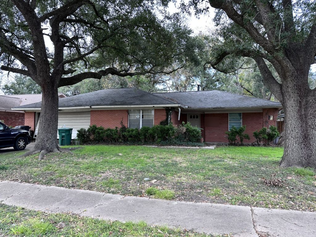 Exterior of Redstart St estate home in Westbury, Southwest Houston TX with major foundation issues, closed for cash as-is by Volcan Property Buyers
