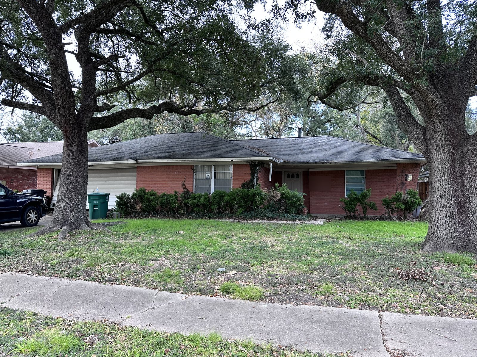 Red brick ranch home under live oaks bought for cash in Westbury, Houston TX