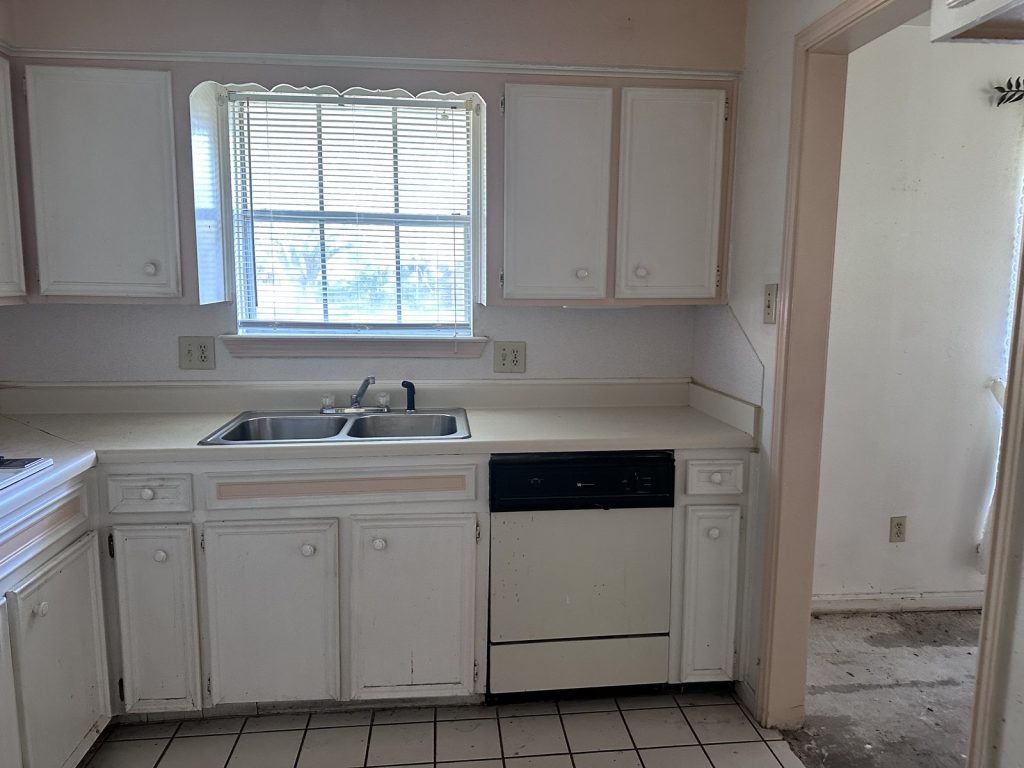 Original kitchen in a vacant, vandalized home purchased for cash in High Meadows, Aldine, TX