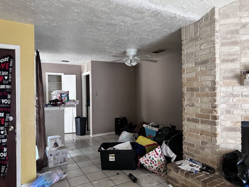 Interior left mid-move in distressed Quail Bridge Houston TX house sold as-is