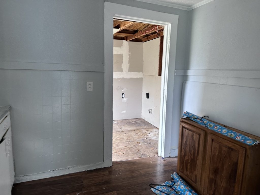 Bedroom with cracked window in rental property sold as-is for cash in Baytown TX