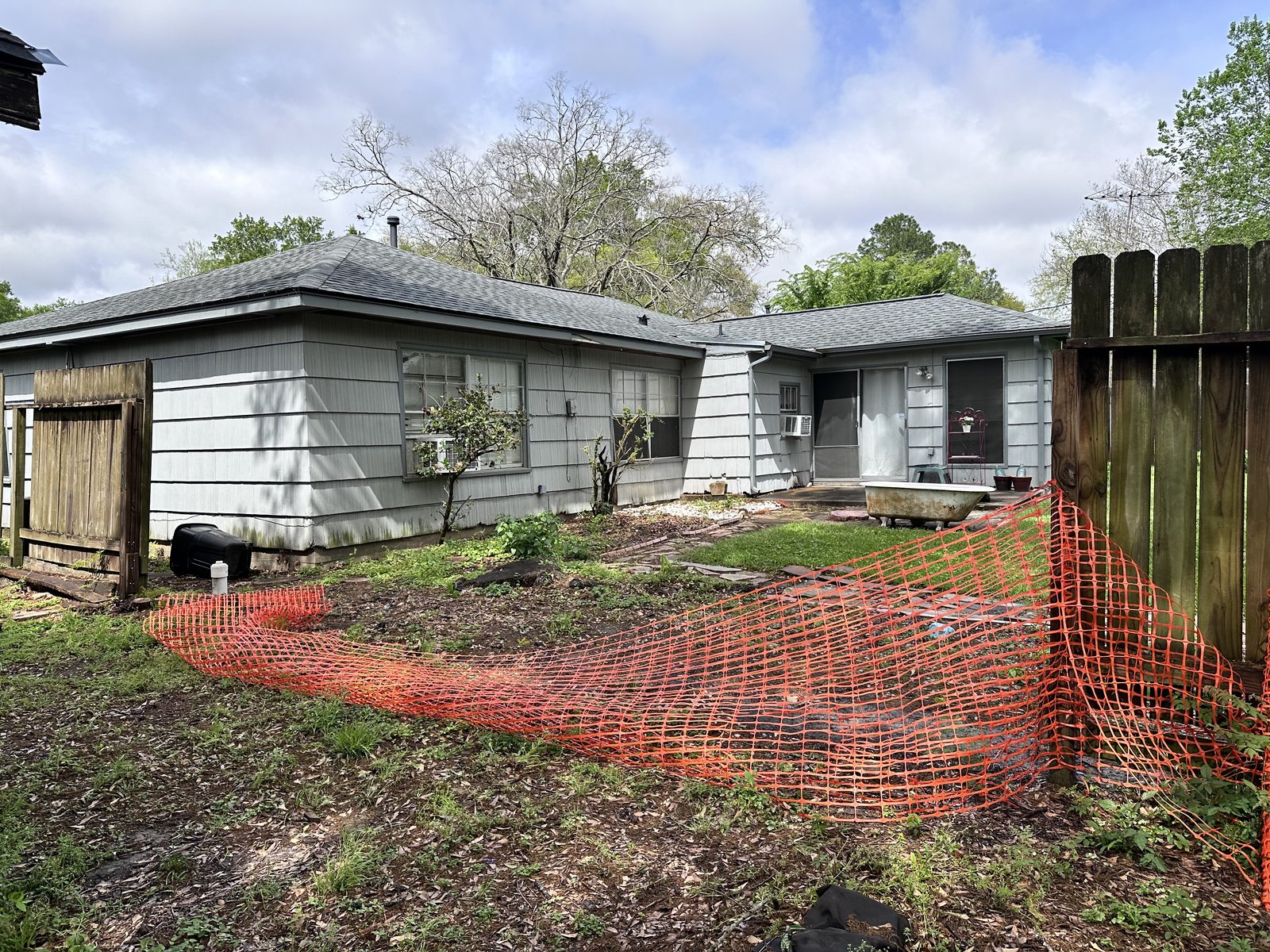 Rear exterior of as-is rental home bought for cash in Robindell, Houston TX