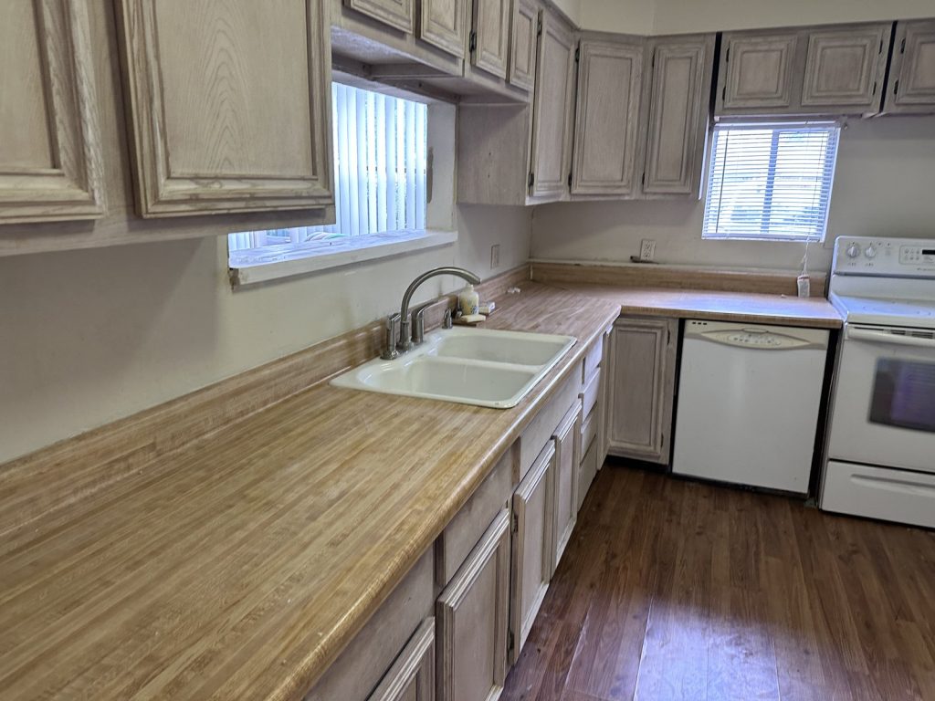 Dated galley kitchen in Robindell Houston TX rental sold for cash