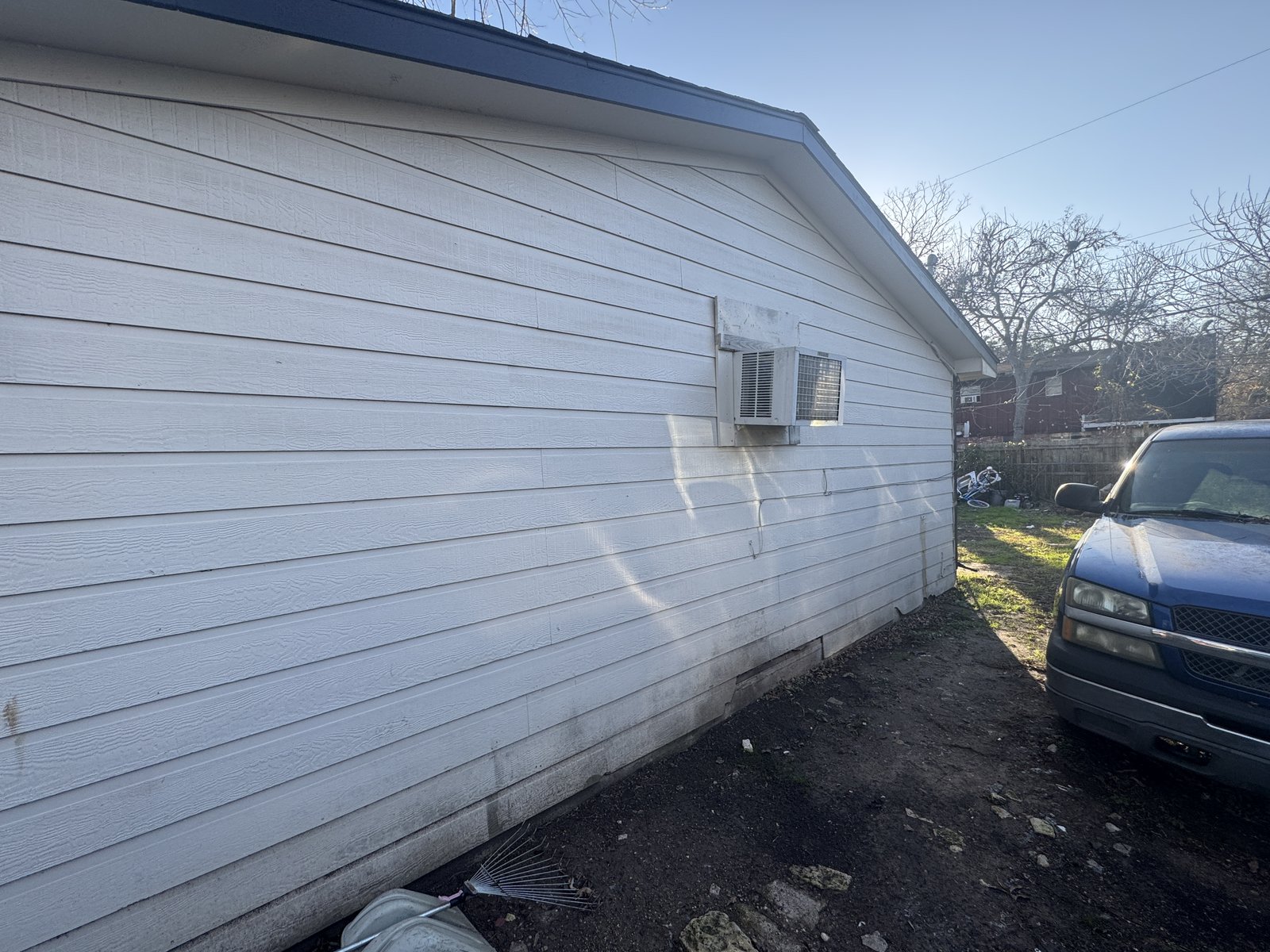Exterior siding and window AC unit at a Sam Mellon rental home in Richmond, TX