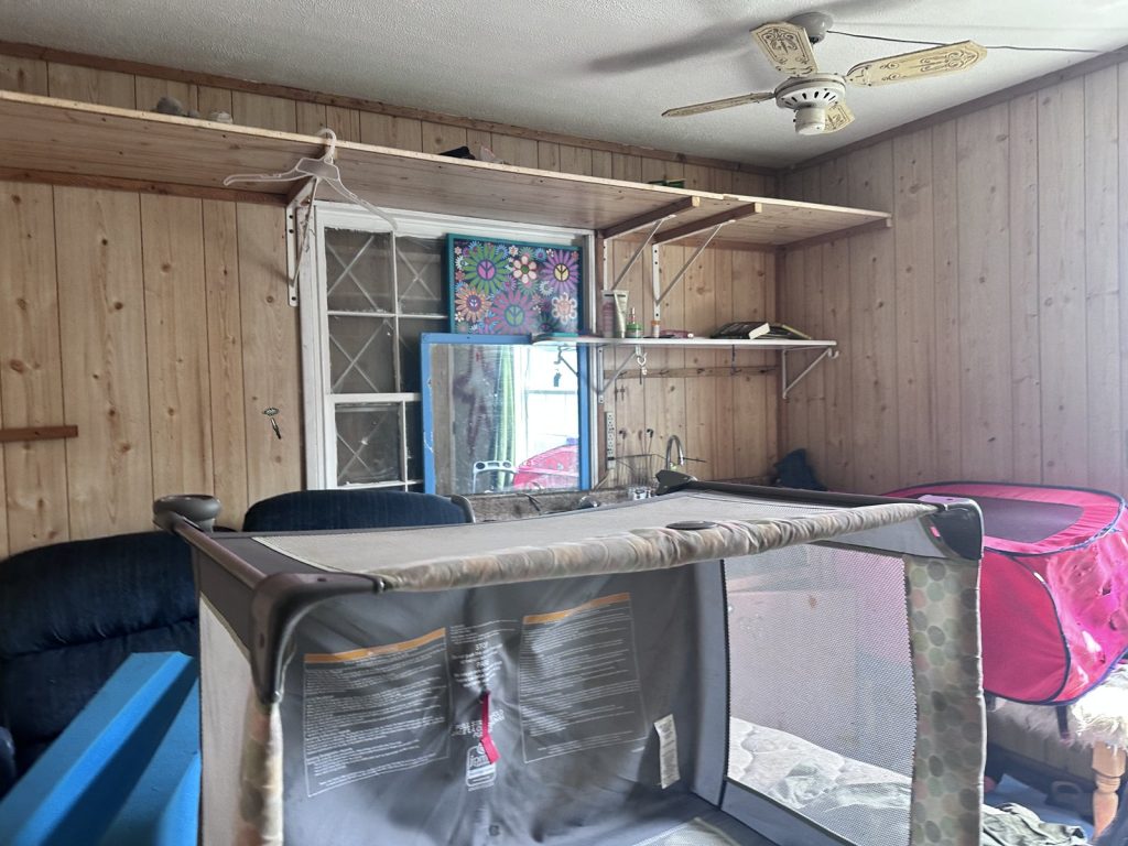 Cluttered storage room in a distressed hoarder property purchased for cash in Greenwood Village, Houston, TX