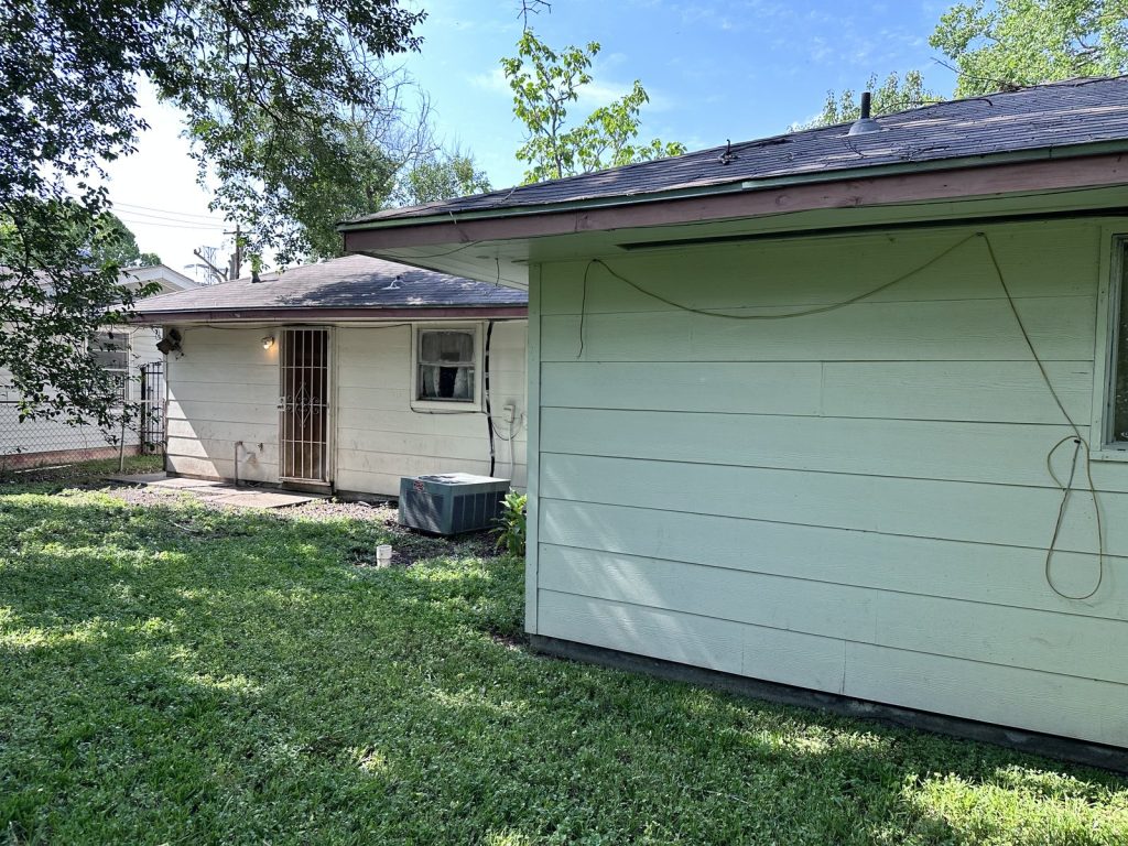 Backyard of vacant Houston TX rental property purchased as-is for cash