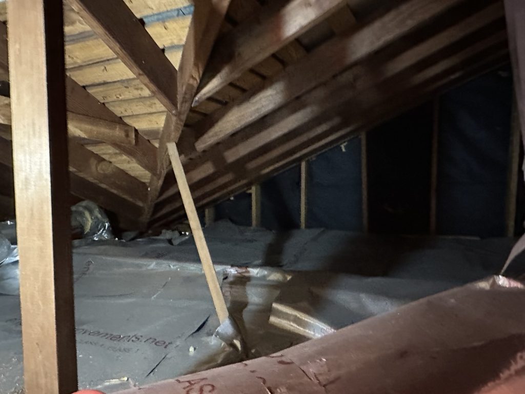 Attic framing showing structural history in Houston TX home bought as-is
