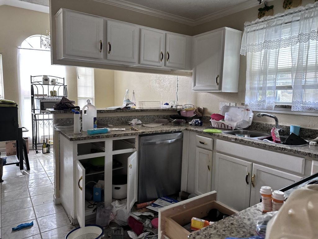 Kitchen with fire and smoke damage cleanup underway in a home sold for cash in Houston, TX