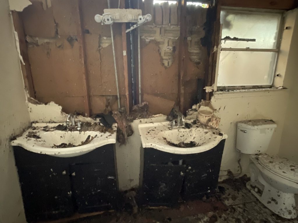 Bathroom gutted by fire in as-is Houston TX home purchased for cash