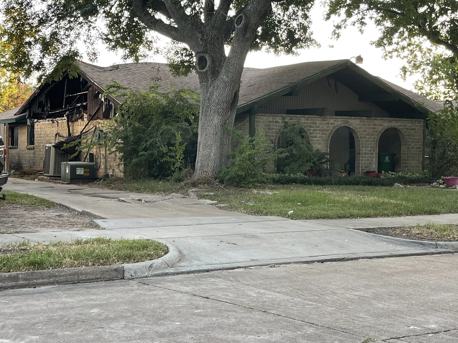 Fire-damaged roof on abandoned brick home bought for cash in Sagemont, Houston TX