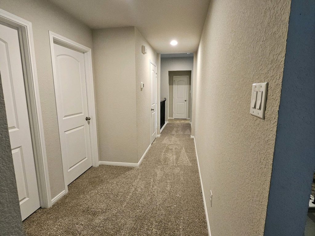 Hallway at a newer-construction Fairwater home in Montgomery, TX